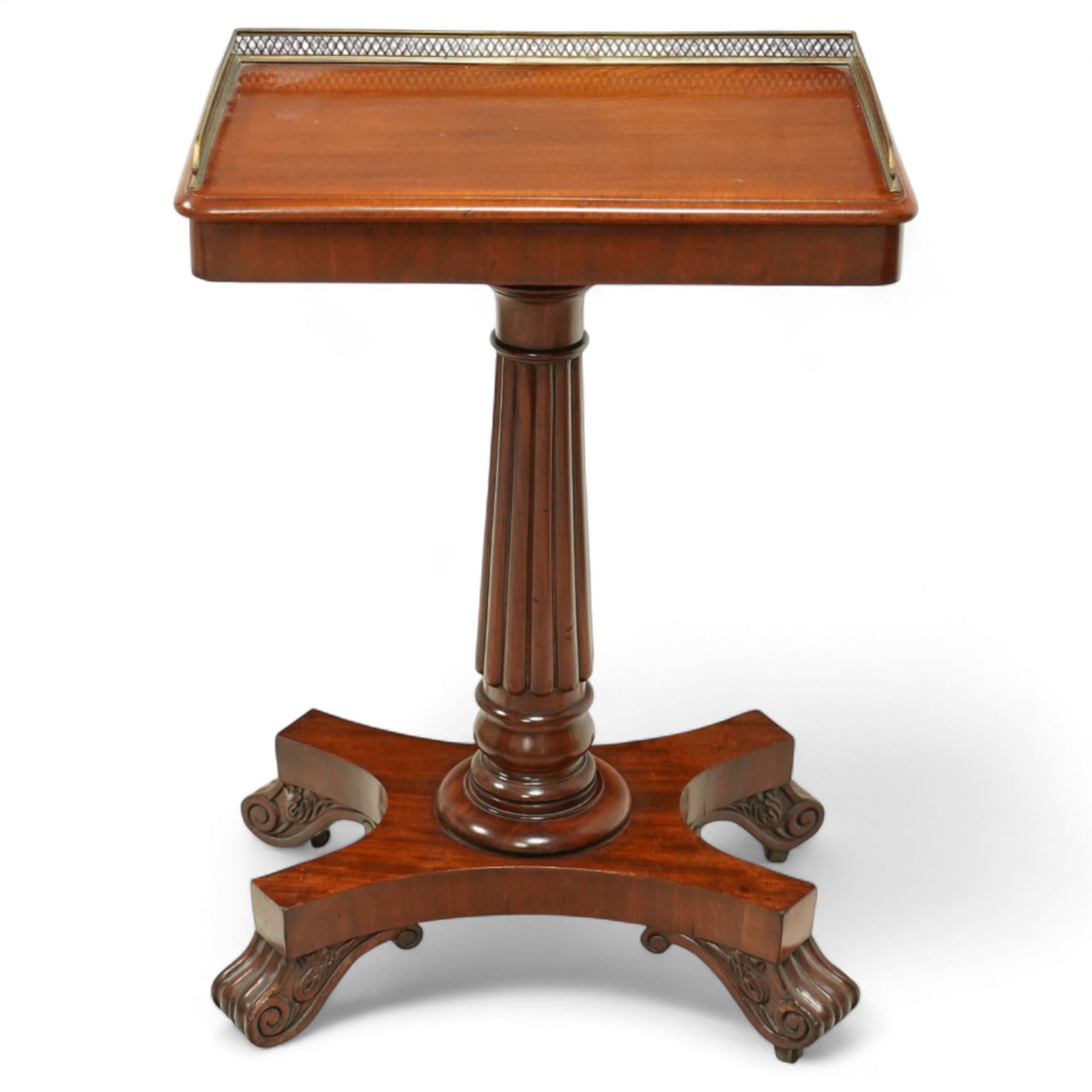 Late Regency mahogany side table in the manner of Gillows, the rectangular top with pierced brass gallery, raised on a reeded column and quatreform base with scroll carved feet with castors 
