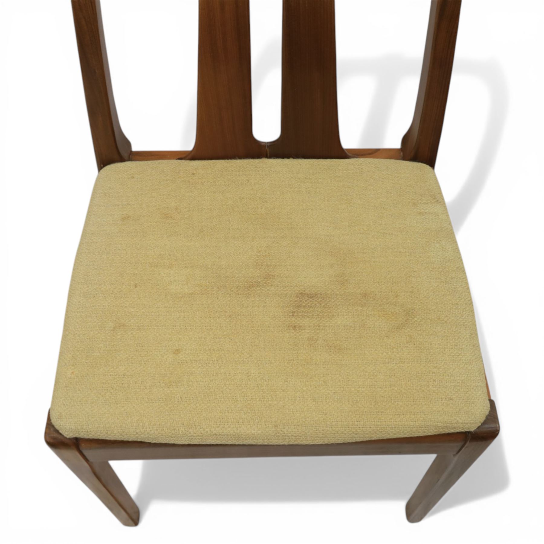 Nathan - teak drop leaf dining table and four Nathan dining chairs, the rectangular top with rounded corners fitted with twin hinged drop leaves and gate legs, extended to form an oval table 174cm in length, raised on square section supports united by stretchers, the chairs with teak frames and padded beige upholstered seat (H 96cm, W 48cm)