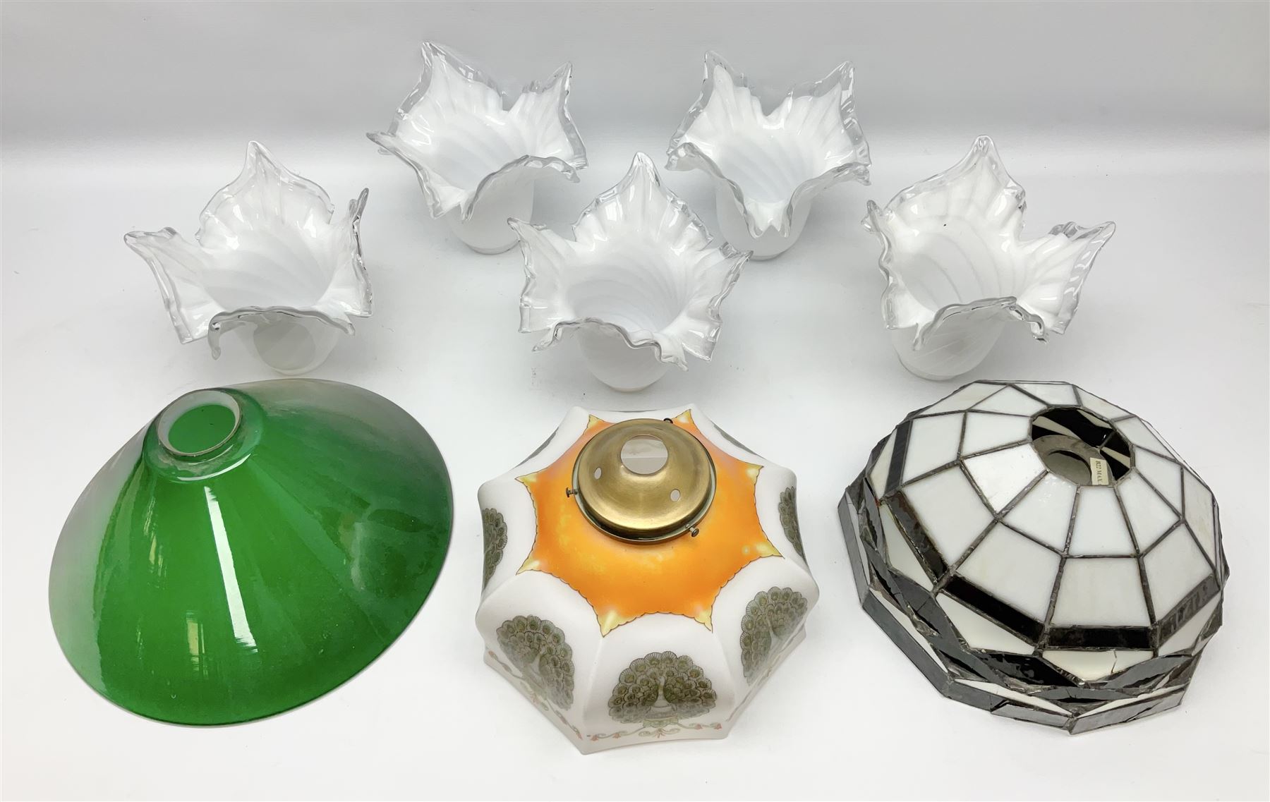 Milk glass lampshade decorated with peacocks, together with a Tiffany style lampshade, a set of five white frilled lamps shades etc 