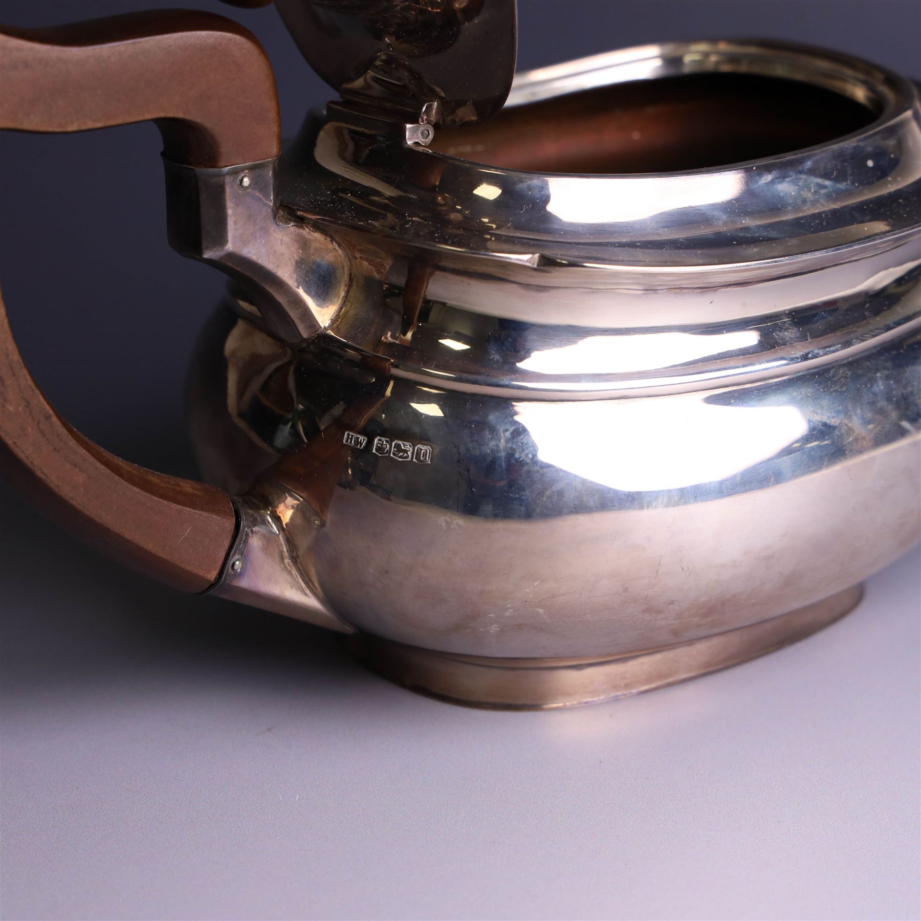1930s three piece silver tea service, comprising teapot with wooden handle and finial, open sucrier and milk jug, hallmarked Viners Ltd, Sheffield 1930