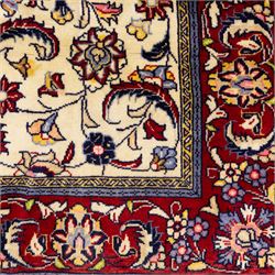 West Persian Sarough hand-knotted rug, ivory field decorated with finely drawn symmetrical lattice of scrolling vines, palmettes and flowering sprays issuing from a subtle central medallion, enclosed by a broad madder-red border of stylized palmettes and foliate vine ornament between multiple guard stripes, with cotton fringe ends 