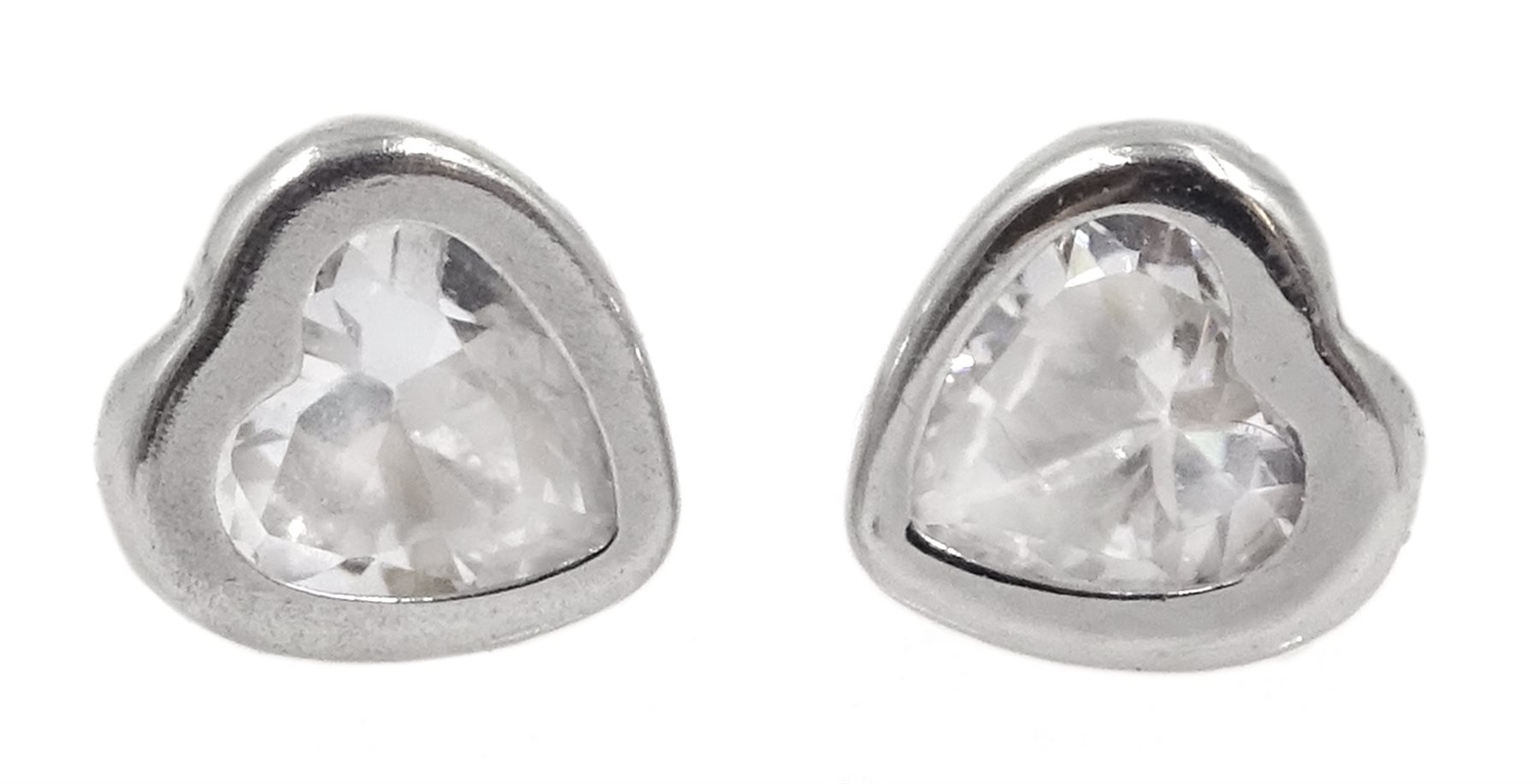 Pair of white gold cubic zirconia heart stud earrings, stamped 9K