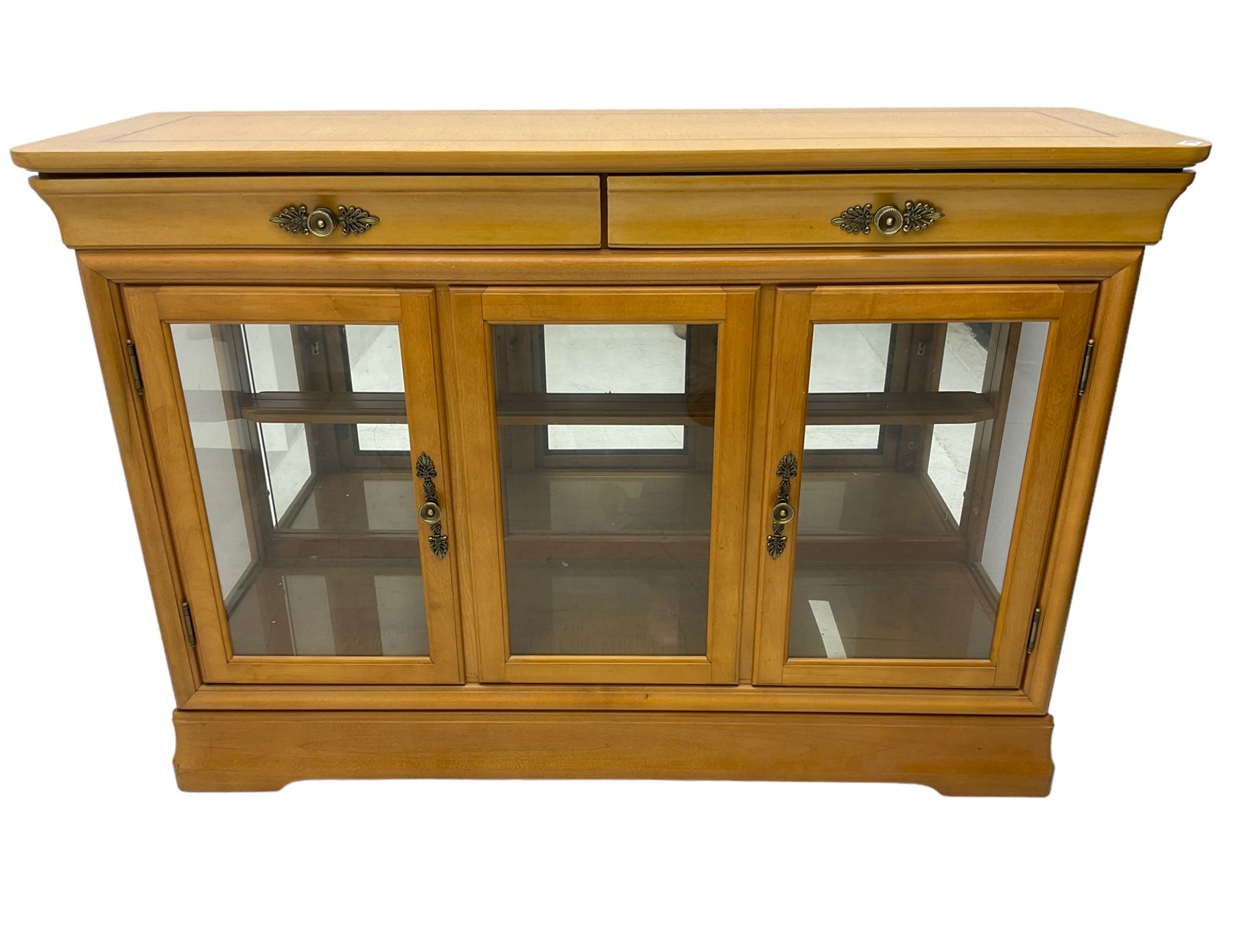 Yew wood sideboard, rectangular top with mahogany and ebony stringing, fitted with two drawers over three glazed cupboard doors enclosing glass shelves