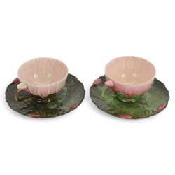 Two Zsolnay Pecs lotus moulded teacups and saucers, with impressed mark beneath