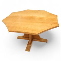 Mouseman - adzed oak octagonal concave dining table, raised on cruciform base, the supports and sledge feet also adzed, carved with fat mouse signature, by the workshop of Robert Thompson, Kilburn