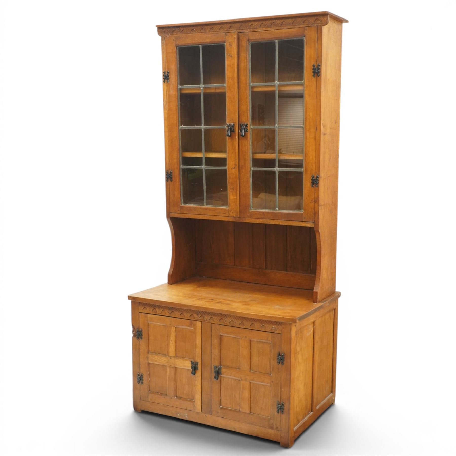 Gnomeman - adzed oak dresser, arcade carved cresting rail over two lead glazed doors, double cupboard below enclosed by two panelled doors, with carved gnome signature, by Thomas Whittaker of Littlebeck 