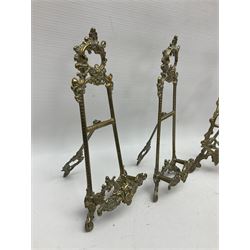 Nine ornate cast brass easel stands of various sizes, H24cm