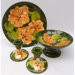  Group of Moorcroft Hibiscus pattern ceramics comprising Comport, H10cm, pair candlesticks and plate, D26cm (4)  