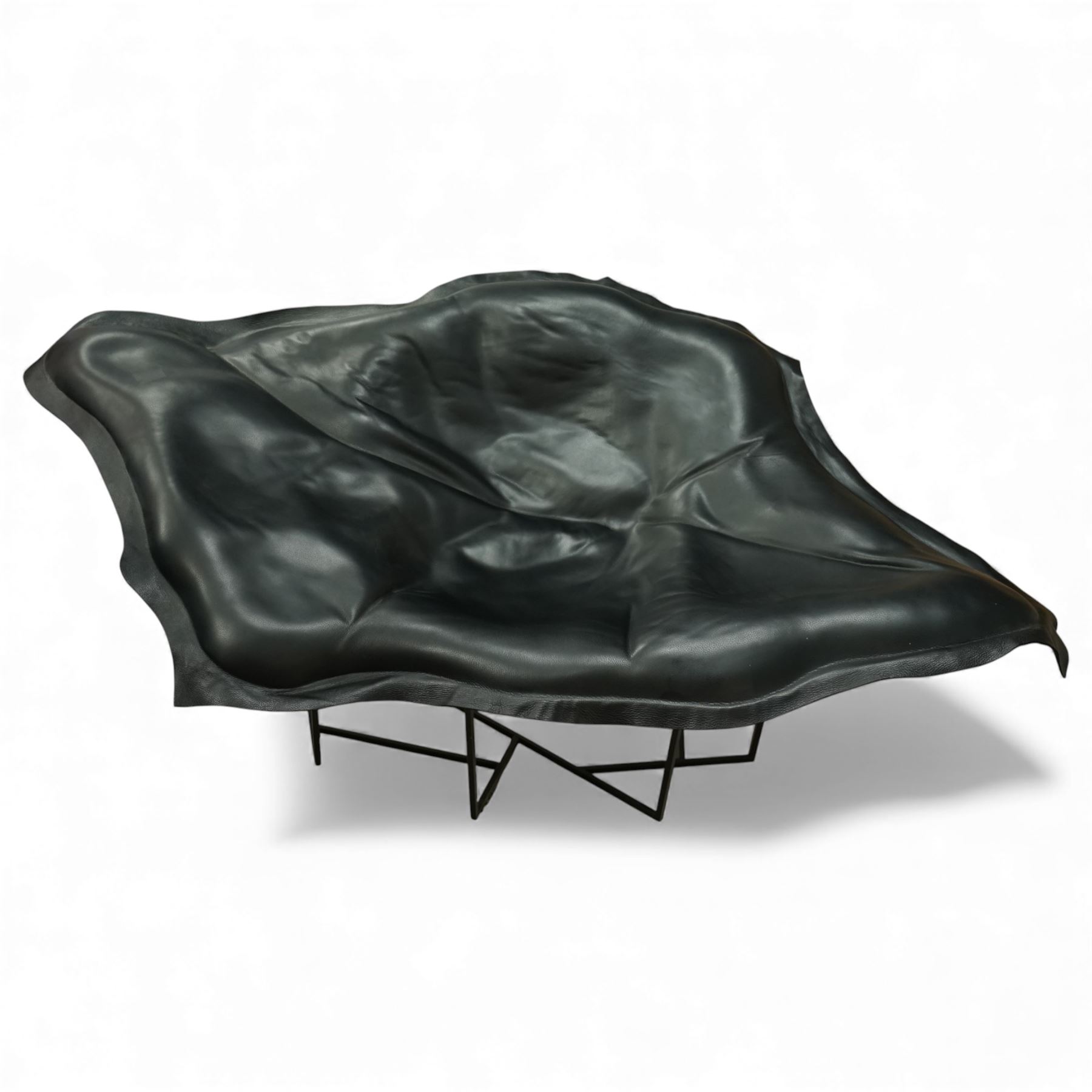 Poliform - ‘Wallace’ armchair, sculptural leaf-form silhouette upholstered in black leather, raised on triangular metal supports