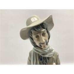 Lladro figure, Violinist, modelled as a man seated upon a  mile stone holding a violin, sculpted by Salvador Furió, no 4887,  year issued 1984, year retired 1981, H35cm