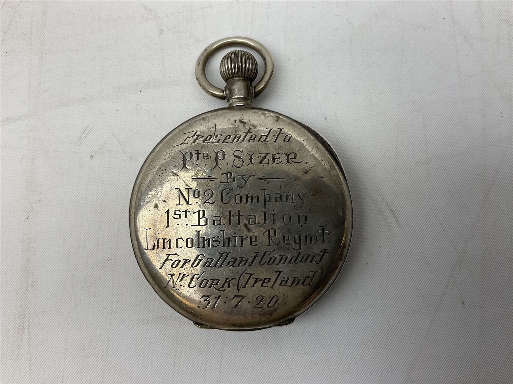 Miniature all nickel 2mm pin fire single shot pistol with engraved grip L4.5cm; together with a .925 silver half hunting cased keyless wind pocket watch inscribed 'Presented to Pte. P. Sizer By No.2 Company 1st Battalion Lincolnshire Regmt For Gallant Conduct Nr. Cork (Ireland) 31.7.20' (2)