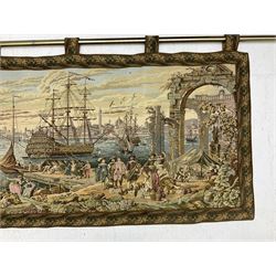 20th century tapestry style wall hanging depicting 17th century port scene, possibly Venice, the harbour filled with traders and merchants, together with a garden scene example depicting a waterfall and lake amongst flowers and trees, both with foliate borders, lined to reverse and suspended from brushed metal poles, largest approx W200cm