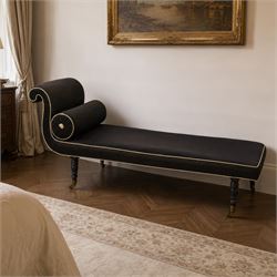 Victorian ebonised chaise longue, upholstered in black fabric with scroll headrest and bol...