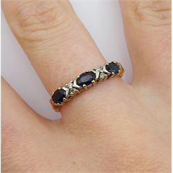 9ct gold three stone oval sapphire ring with four round brilliant cut diamonds set between, hallmarked 