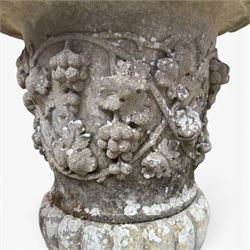 Pair of quality antique weathered three-piece composite stone garden urns, the flared rim moulded with repeating acanthus leaves, over a deep-relief campana body decorated with fruiting grapevines and ivy leaves, the gadrooned underbelly over a turned socle and square base