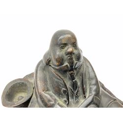 Cast metal inkwell in the form of a man sat eating a roast bird, possibly depicting  Daniel Lambert, H10cm. 