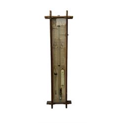 Oak cased Admiral Fitzroy barometer c1890 - with original full height paper scales annotated with Fitzroy's remarks and observations, brass sliding pointers above a Fahrenheit and centigrade spirit thermometer and storm glass, large bore bulb cistern tube with a mechanical sealing tap, in a fully glazed reformed gothic influenced case with chamfered moulded uprights, top, and base.