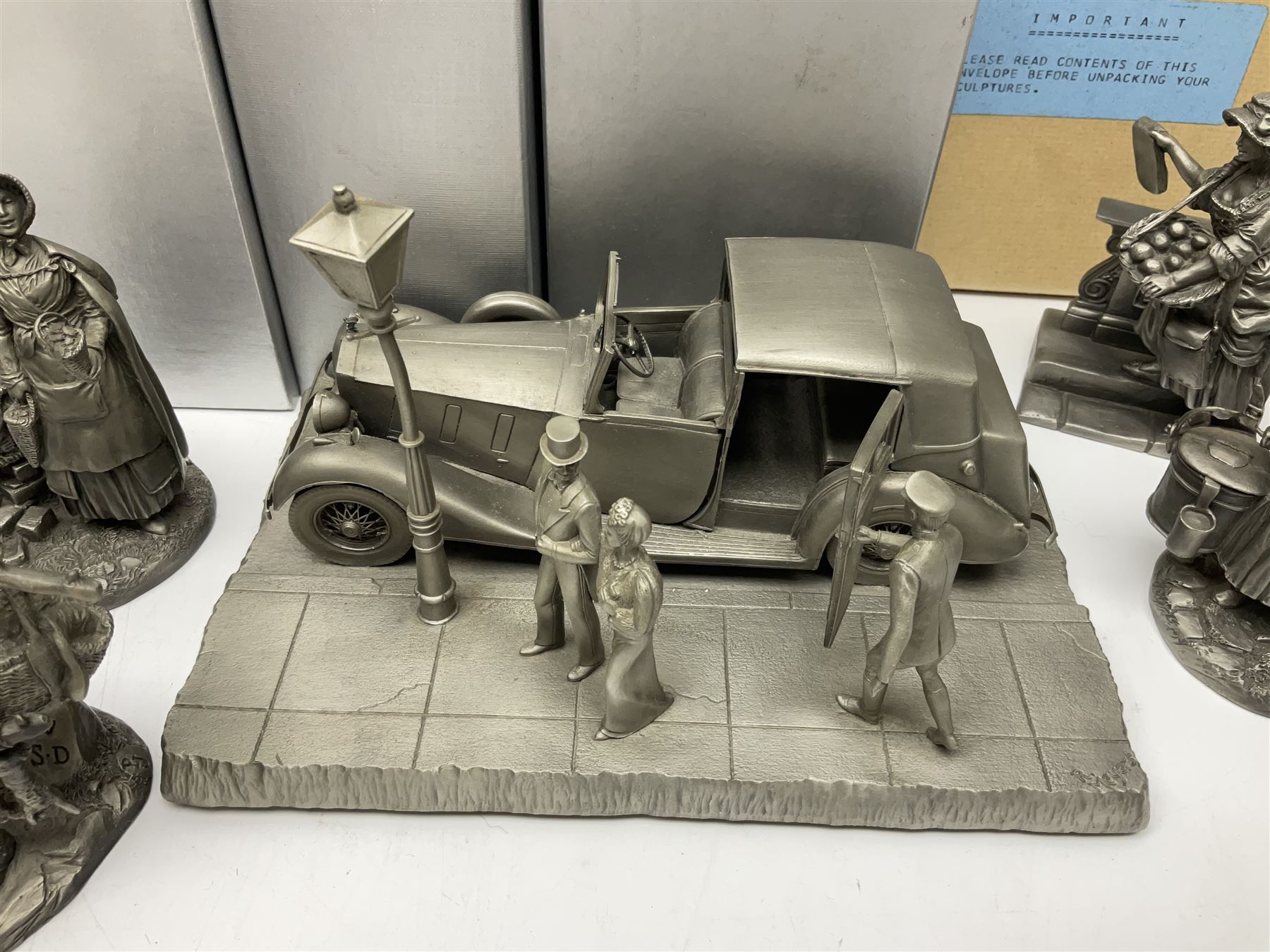 Twelve Franklin Mint pewter figures, to include some from the Cries of London series, together with a Franklin Mint 1937 Rolls Royce Phantom III pewter model and Danbury Mint Christmas bells