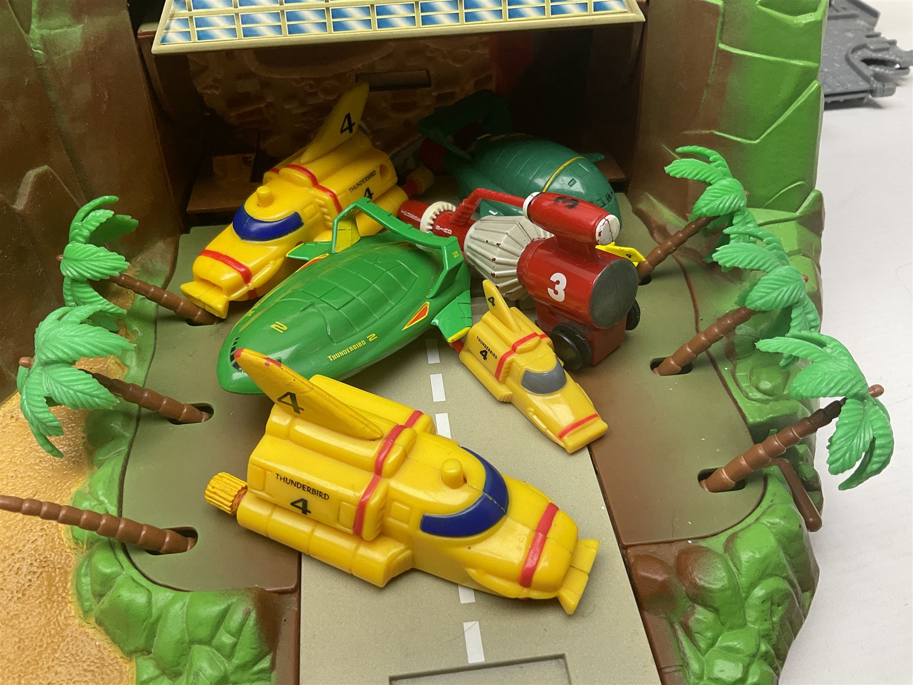 Quantity of Thomas the Tank Engine playsets and track, and Thunderbirds 2004 Tracy Island playset with some associated vehicles, in two boxes 