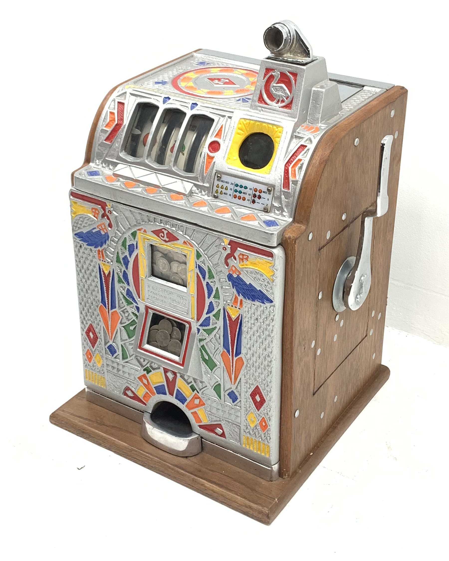 A one arm bandit fruit slot machine, the oak case with cast metal front and top with polychrome detail, with jackpot windows and single pull arm, patent no to front, H62cm. 