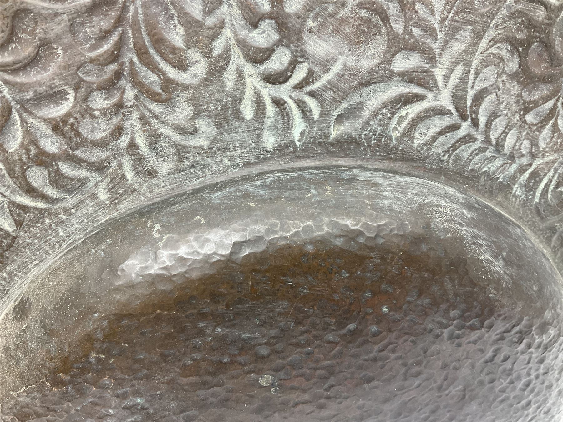 Arts and Crafts Keswick School of Industrial Arts copper charger, decorated with planished centre and repousse scrolling foliate tendrils to rim, D44cm