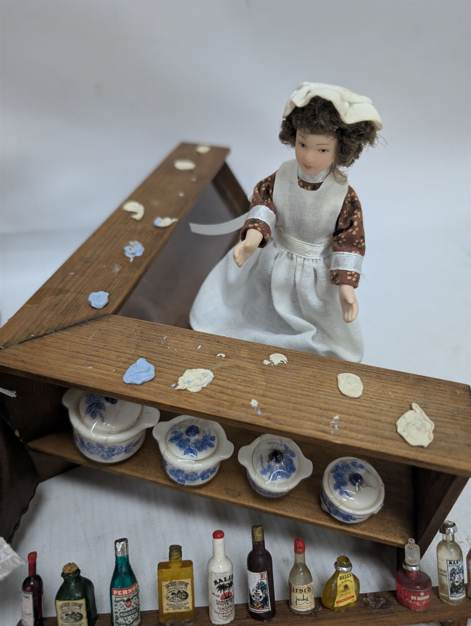 Victorian and later style dolls house kitchen furniture, including countertop, dresser displaying copper pots and blue and white ceramics, baking table, oven, three figures and a collection of food and baking accessories