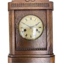 German striking mantle clock in an oak case by the Hamburg and American Clock company, with an 8-day spring driven movement, striking the hours on a coiled gong.