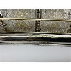 Early 20th century silver plated tantalus by John Grinsell & Sons of Birmingham, containing two crystal glass decanters, with key, H31cm