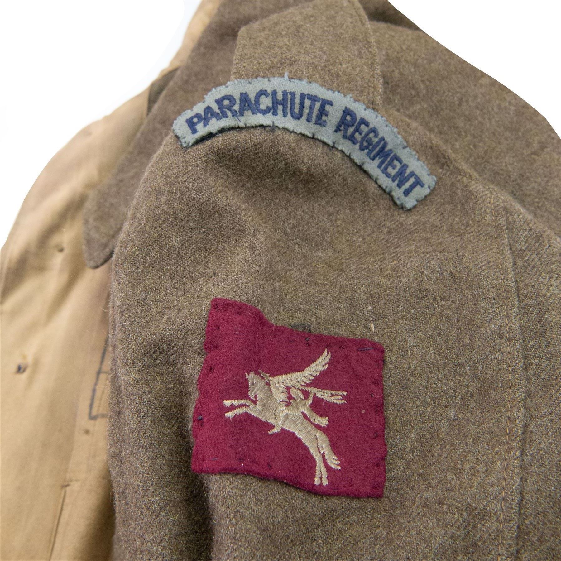 WWII British parachute regiment battle dress uniform, the jacket with shoulder title and Pegasus formation badge to the left arm, shoulder title, Pegasus formation badge and cloth wings to the right, size 3 dated 1943, the trousers size 3 dated 1945 