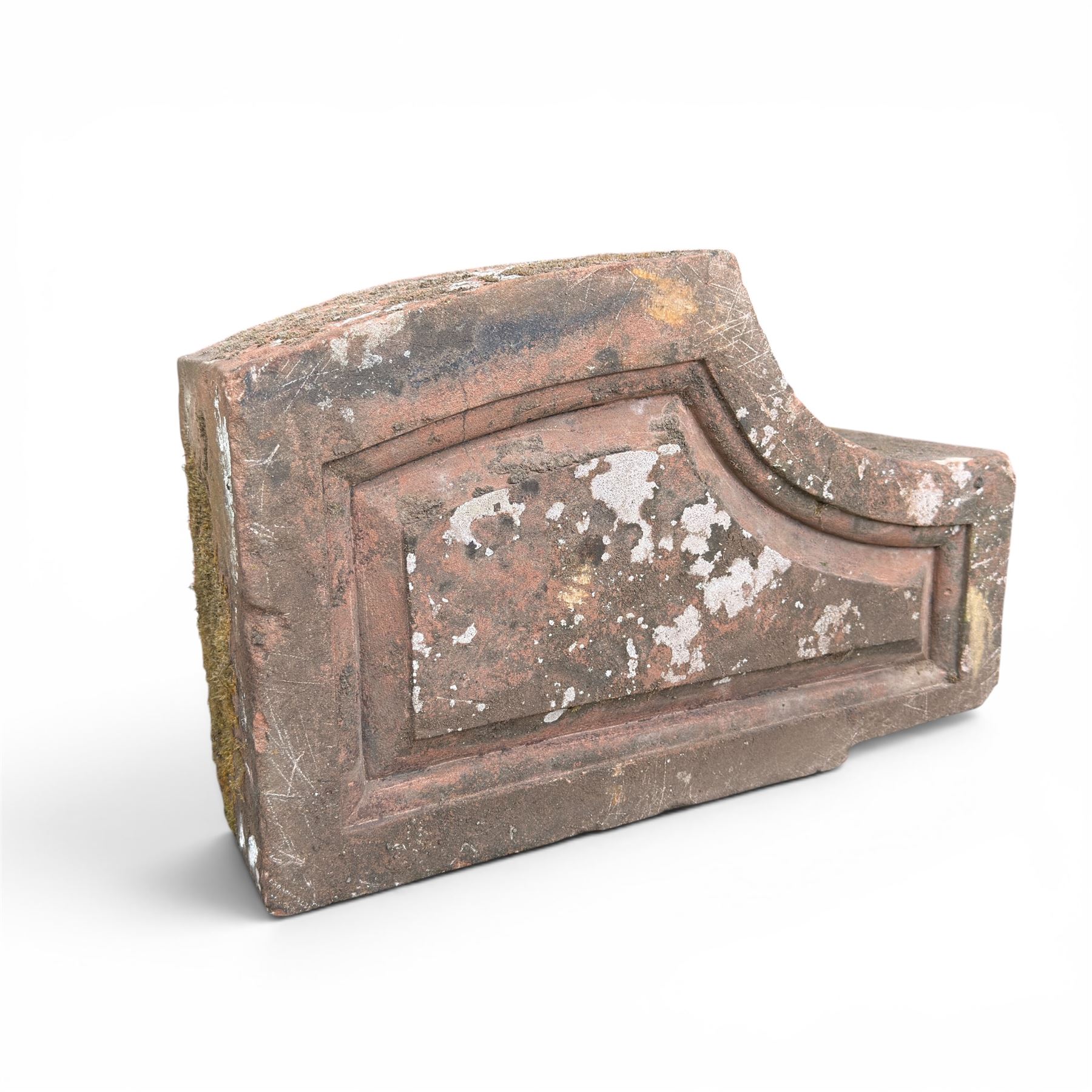 Pair of 19th century hewn and carved stone wall ends, the facias carved as shaped faux fielded panels