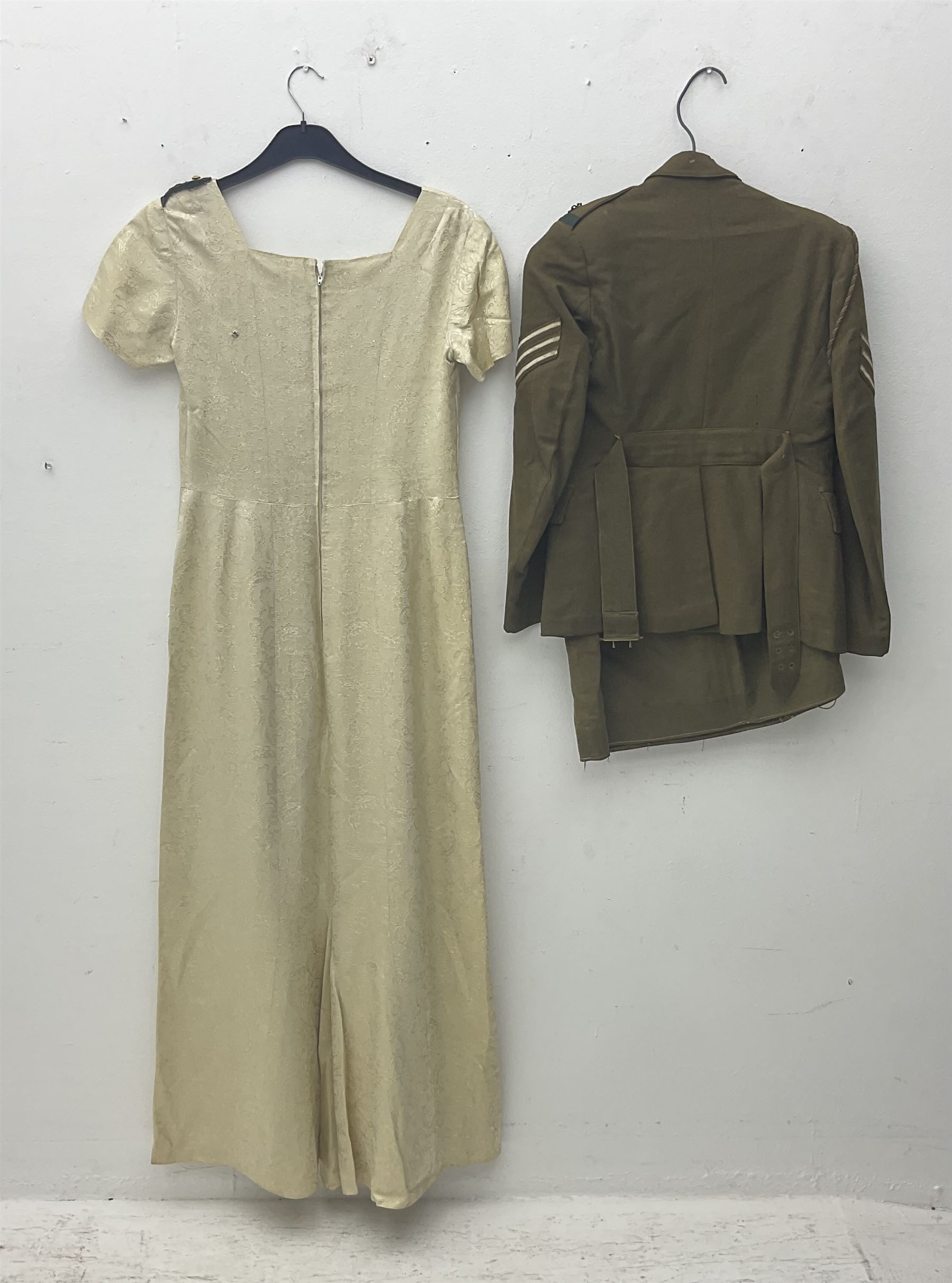 WW2 British female ATS Sergeant's service uniform grouping, consisting of four pocket female pattern service dress tunic with brass ATS shoulder titles and general service buttons; cloth lined interior with the original printed size label dated 1942; the matching khaki service dress skirt; and Greatcoat with size label dated 1945; together with army knitted sleeveless V-neck jumper; WRAC tunic, skirt and overcoat; full length cream and gold thread military evening dress by Hilliers Couture; and four webbing belts