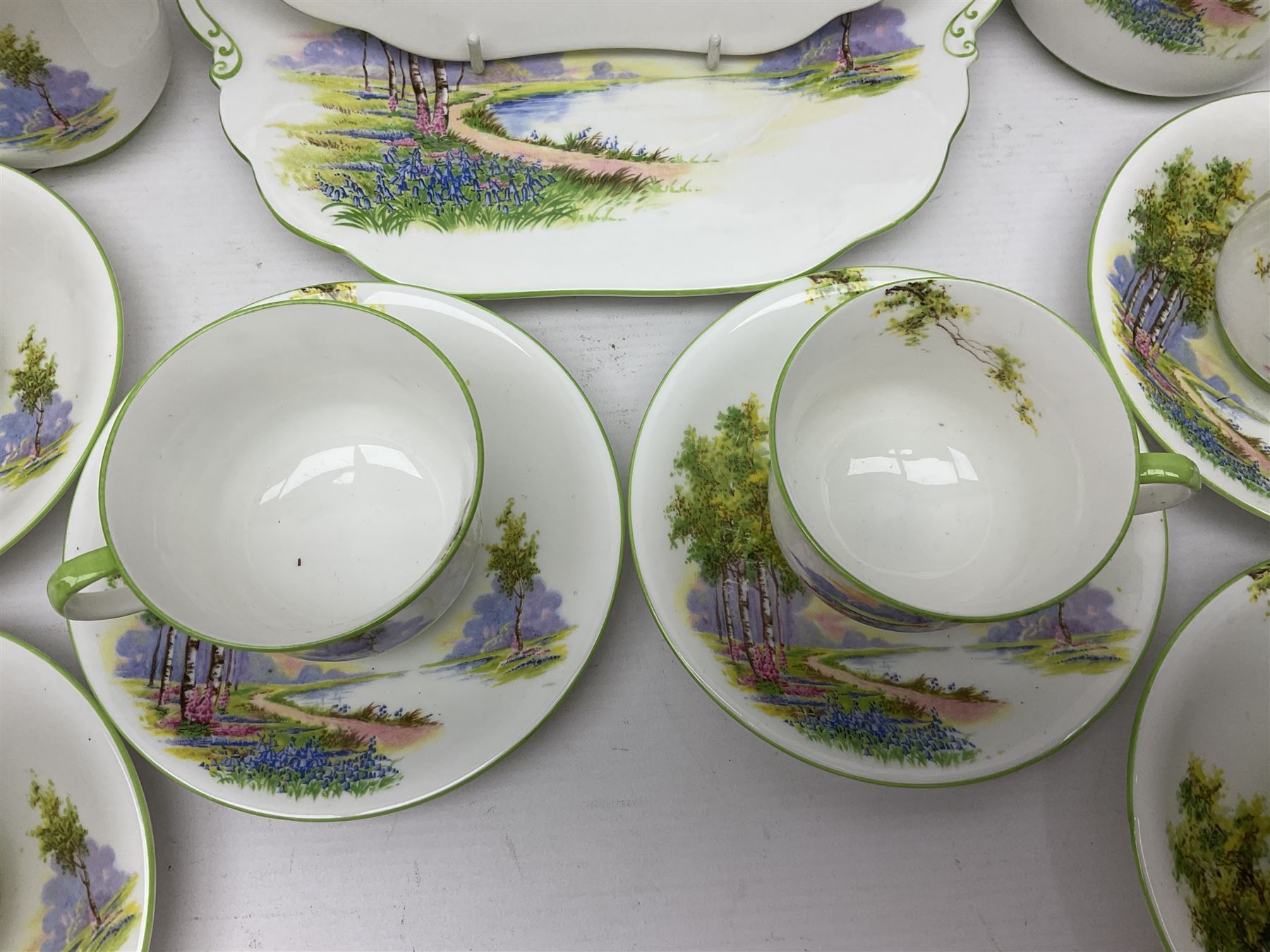 Aynsley Bluebell Time 'As Supplied to the Queen' tea service, comprising hot water jug, six teacups and saucers, milk jug, two cake plates and tow trinket dishes  