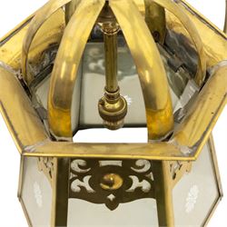 Arts & Crafts brass hall lantern, circa 1900, of hexagonal tapering form with open dome top support and pierced foliate detail above frosted glass panels with flower head detail, H41.5cm D29cm