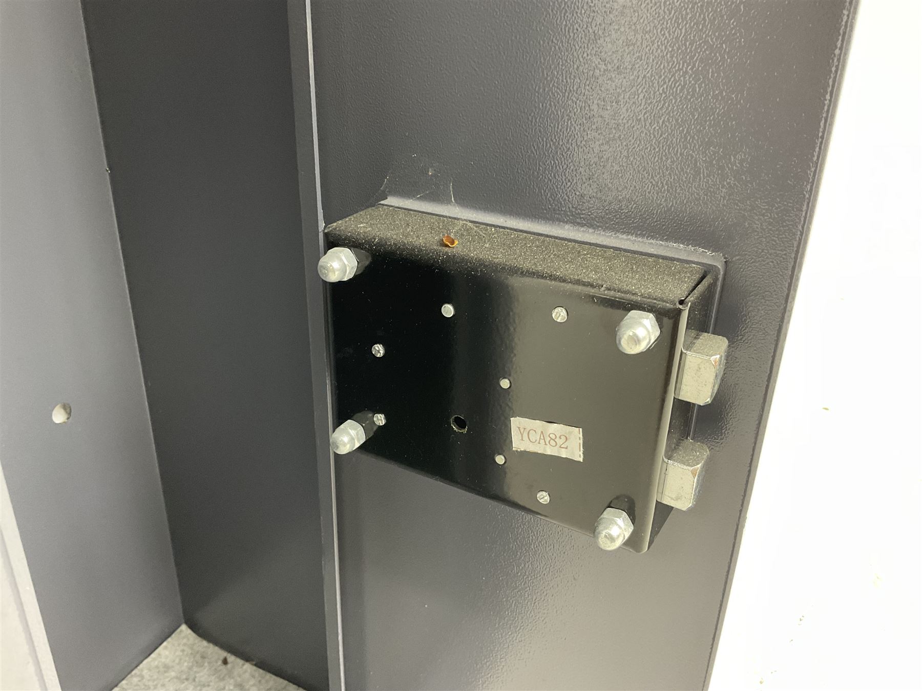 Grey steel wall mounting gun cabinet to accommodate three guns; single door with two locks with two keys for one lock; internally H128.5cm W21cm D17.5cm; externally H129cm W21.5cm D20cm