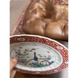 Chinese Kangxi famille verte plate, decorated with a bird perched upon a blossoming branch, within an iron red foliate border, D22cm