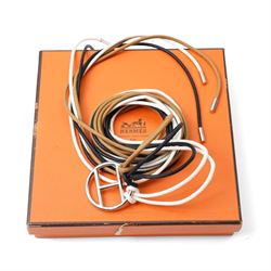 Hermès - long multi-cord belt in black, white and camel, suspending a large palladium-tone circular openwork H pendant, signed HERMES, in original box