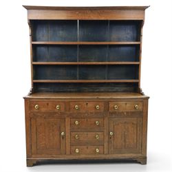 18th century Georgian oak dresser and rack, three back-boarded plate shelves, above six drawers and two cupboards, raised on bracket feet
