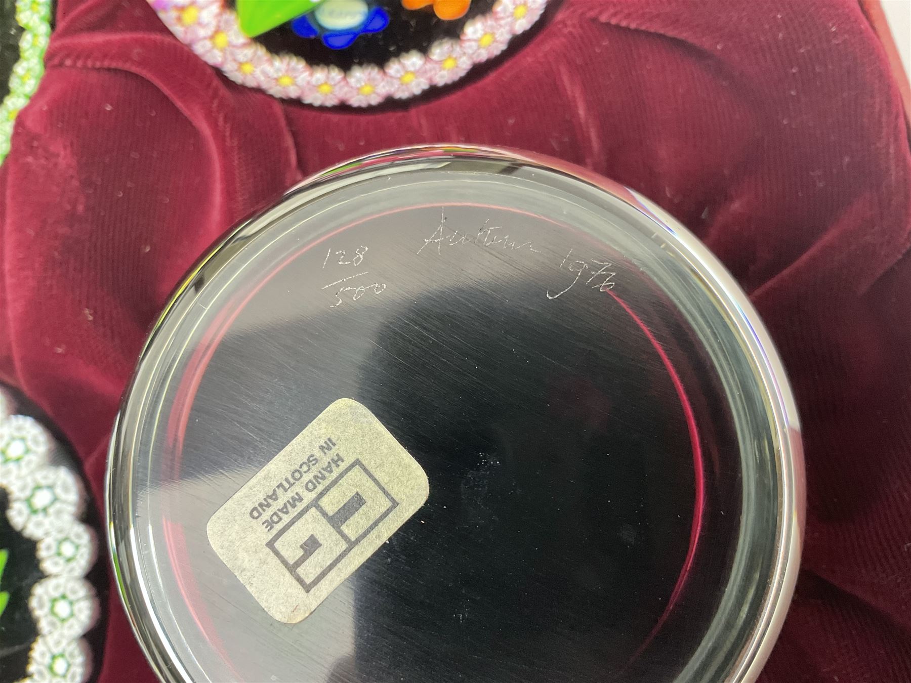 Set of four Caithness paperweights titled Four Seasons, in presentation box with certificate, designed by Colin Terris and made by William Mason, each internally decorated with a seasonal flower within a millefiori cane work garland, numbered 128 of 500