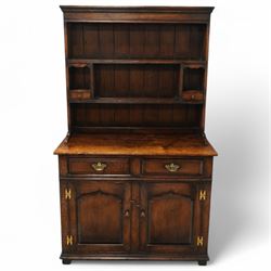 Contemporary georgian style oak dresser, open rack top with two shaped shelves and small side drawers, base with rectangular top over two drawers with brass swing handles, twin arched panelled doors below, on bracket feet