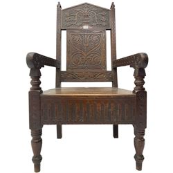 17th century design oak wainscot chair, the back profusely carved with scrolling foliate motifs, the arms carved with repeating guilloche decoration over an arcade apron and turned supports