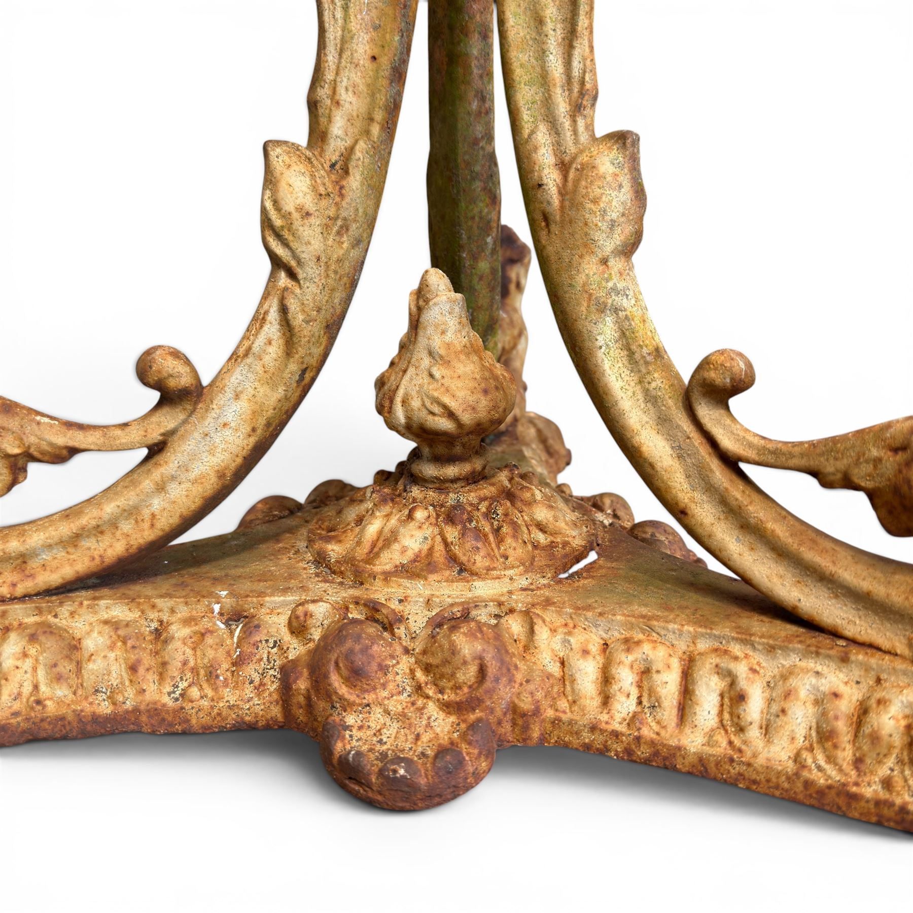Victorian cast iron garden table, circular pierced top with foliate and scroll decoration, raised on an ornate tripod base with natural weathered paint finish.