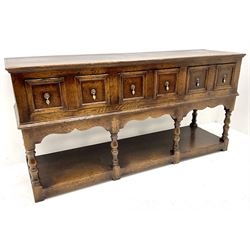 18th century style oak dresser base, three drawers above baluster turned supports on a pot board base