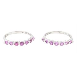 Two 9ct white gold pink sapphire half eternity rings, each set with seven round cut sapphi...