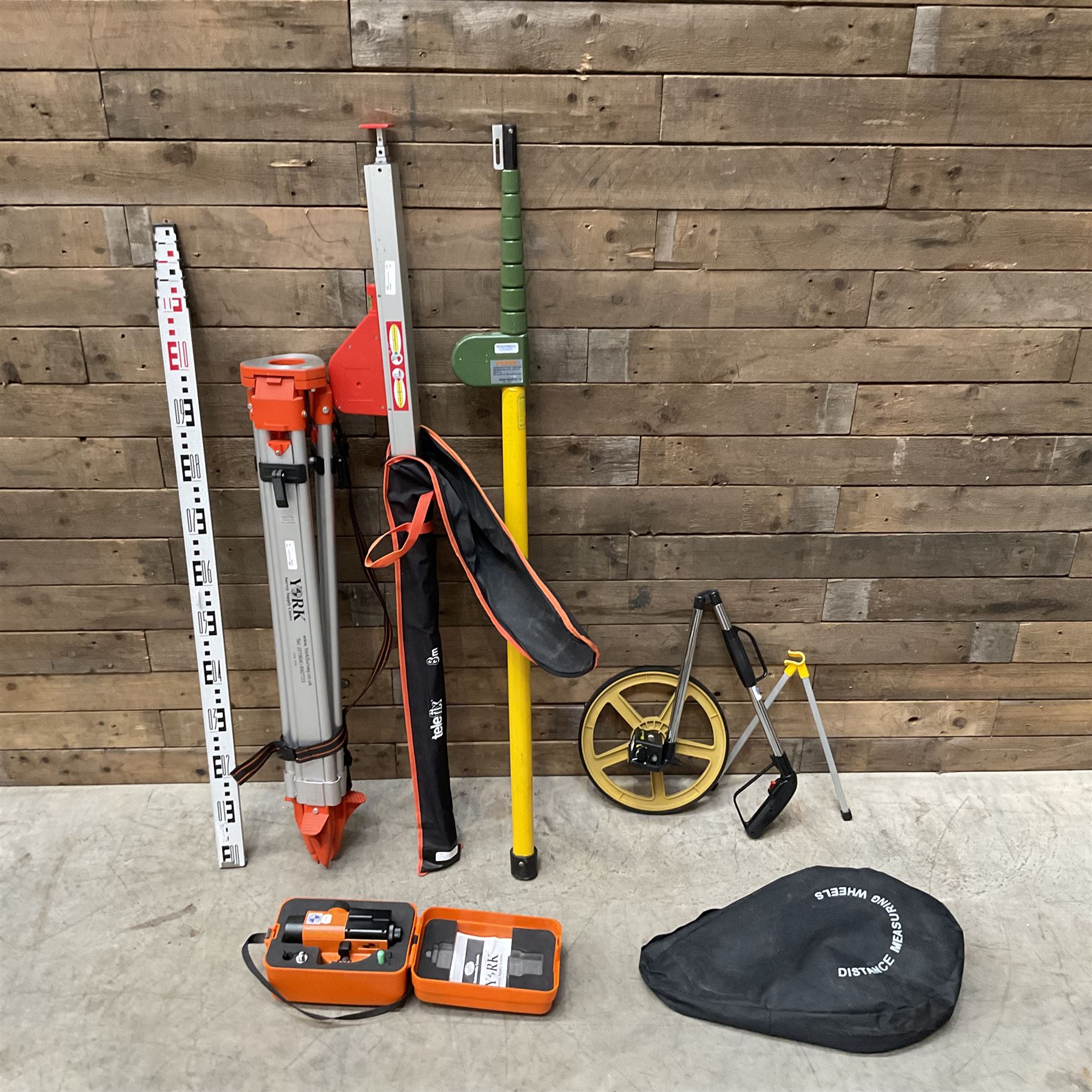 Collection of surveyors equipment including an automatic level and tripod stand and Hilka Pro Craft distance measuring wheel