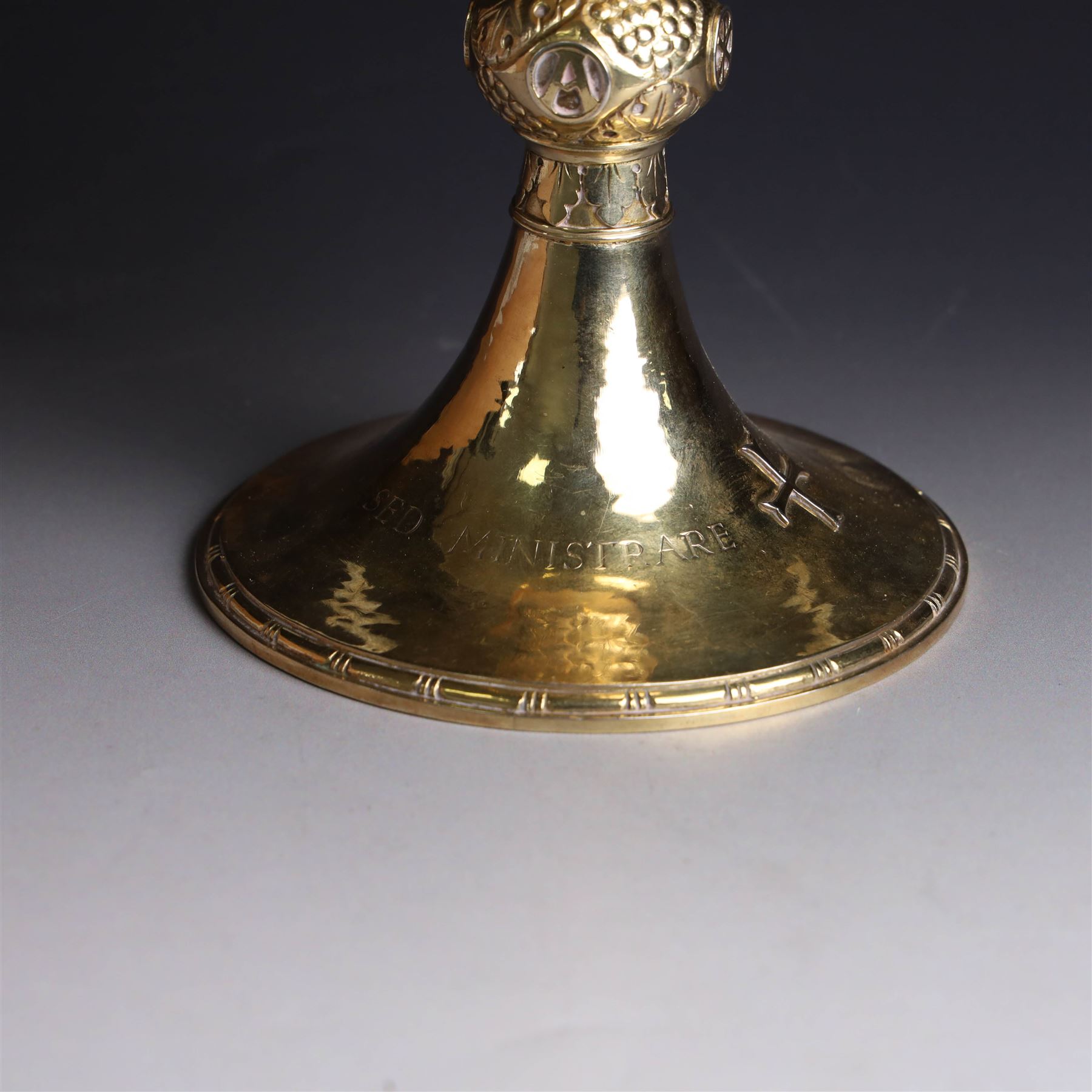 Mid 20th century silver-gilt chalice, the goblet with hammered finish upon knopped stem, the knop embossed with symbols and foliate decoration, engraved to base ' veni non ministrari sed ministrare' and with presentation engraving to underside, hallmarked Guild of Handicraft, London 1957, H17cm