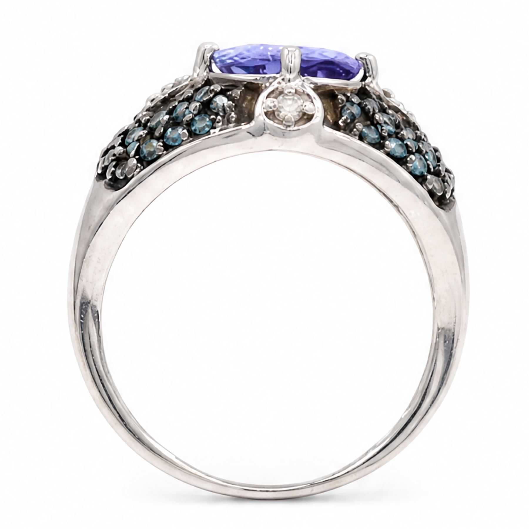 9ct white gold tanzanite and diamond ring, single oval cut tanzanite of approx 1.70 carat, surrounded by four single cut white diamonds and pave set blue diamonds, hallmarked