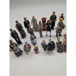 1:12 scale dolls house composite figures, including policeman, postman, maid, sitting and standing people in various styles of dress, etc