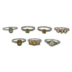Seven 9ct white gold stone set rings, including three stone opal ring and oval green stone solitaire ring, all hallmarked 