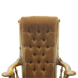 Near pair of late 20th century oak high back armchair, upholstered in brown fabric with buttoned back and close-nailed borders, shaped arms on turned supports, over a stuff-over seat, raised on turned legs united by stretchers
