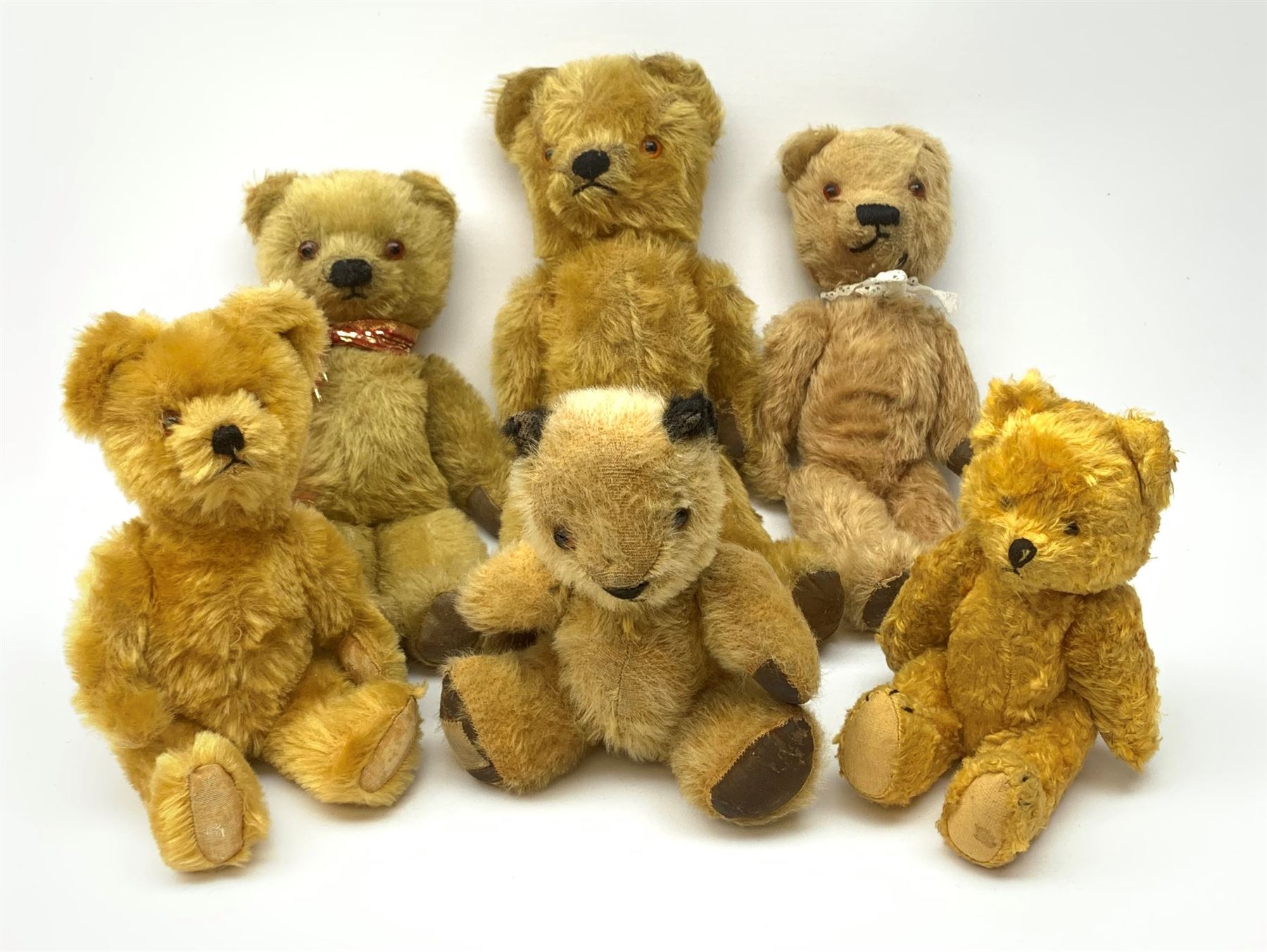 Six 1950s small teddy bears including Chad Valley Sooty type with glass type eyes, horizontal stitched nose and mouth and jointed limbs H9